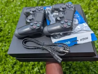 PS4 With 2 Controllers and 8 Games (FC27 and Others)