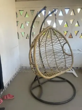 A Beige Woven Rattan and Metal Hanging Egg Swing Chair