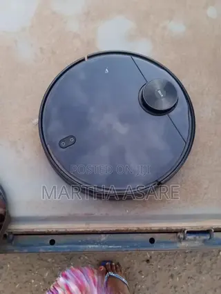 The Image Shows a Wyze Robot Vacuum, a Smart Automated Cleaning Device