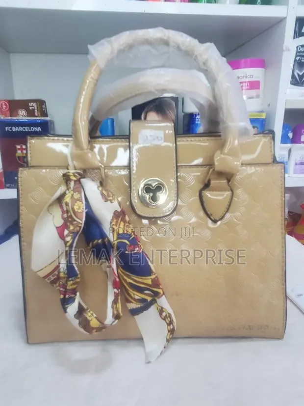 Beige Embossed Patent Leather Top-Handle Handbag With Scarf. · Photo 1