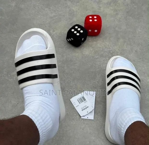 These Are the White Adidas Slide Sandals Three Distinct Black Stripes · Photo 1