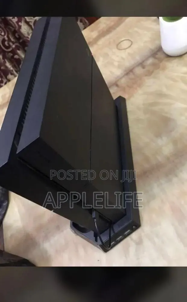 PlayStation 4 With 5 Games FIFA26 and More · Photo 1