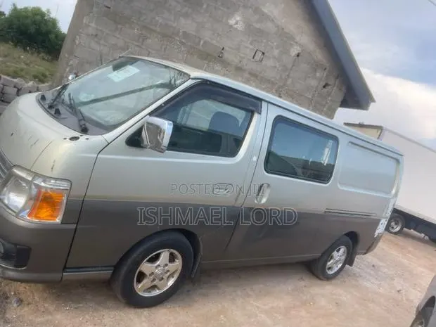 Nissan Caravan (Urvan) 2014 Brown · Photo 1