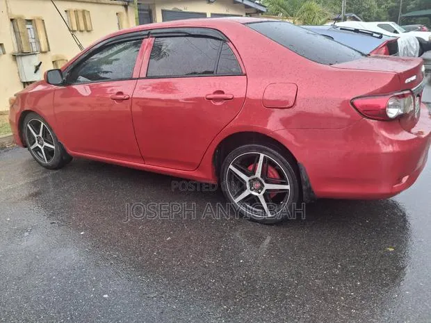 Toyota Corolla L 4dr Sedan (1.8L 4cyl 5M) 2013 Burgundy · Photo 1