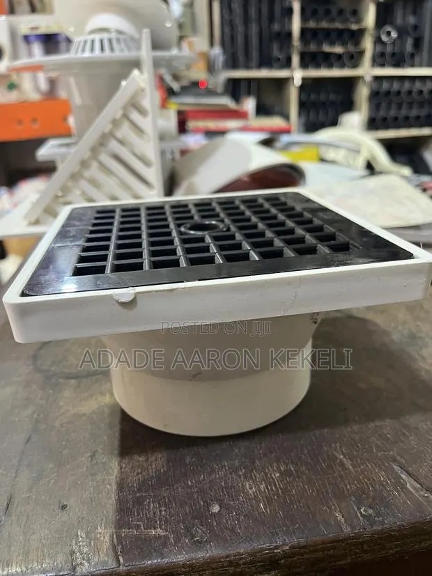 Heavy-Duty PVC Floor Drain With Black Grid Strainer Cover · Photo 1