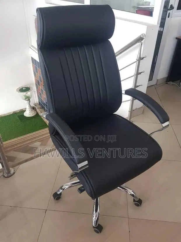 Black Leather High-Back Chair With Chrome Accent and Fixed Armrests. · Photo 1