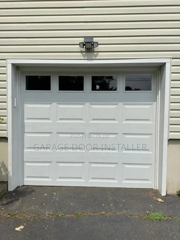 Automatic Garage Door With Remote and Glass Windows · Photo 1