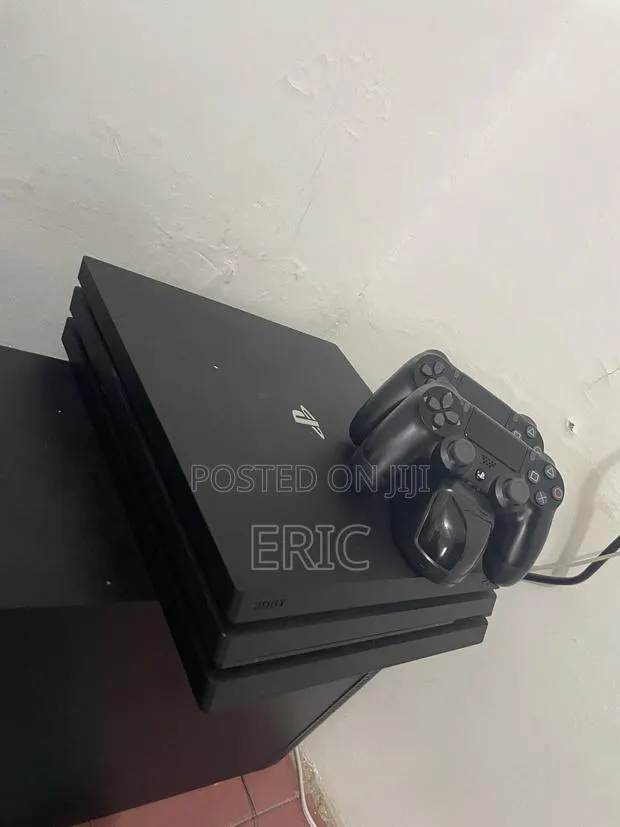 PS 4 Pro With All the Cables 2 Pads With a Charging Pot · Photo 1