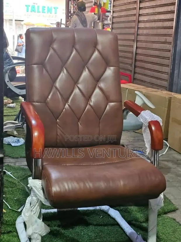 Brown Leather Executive Chair With Wooden Armrests and Slede Base · Photo 1