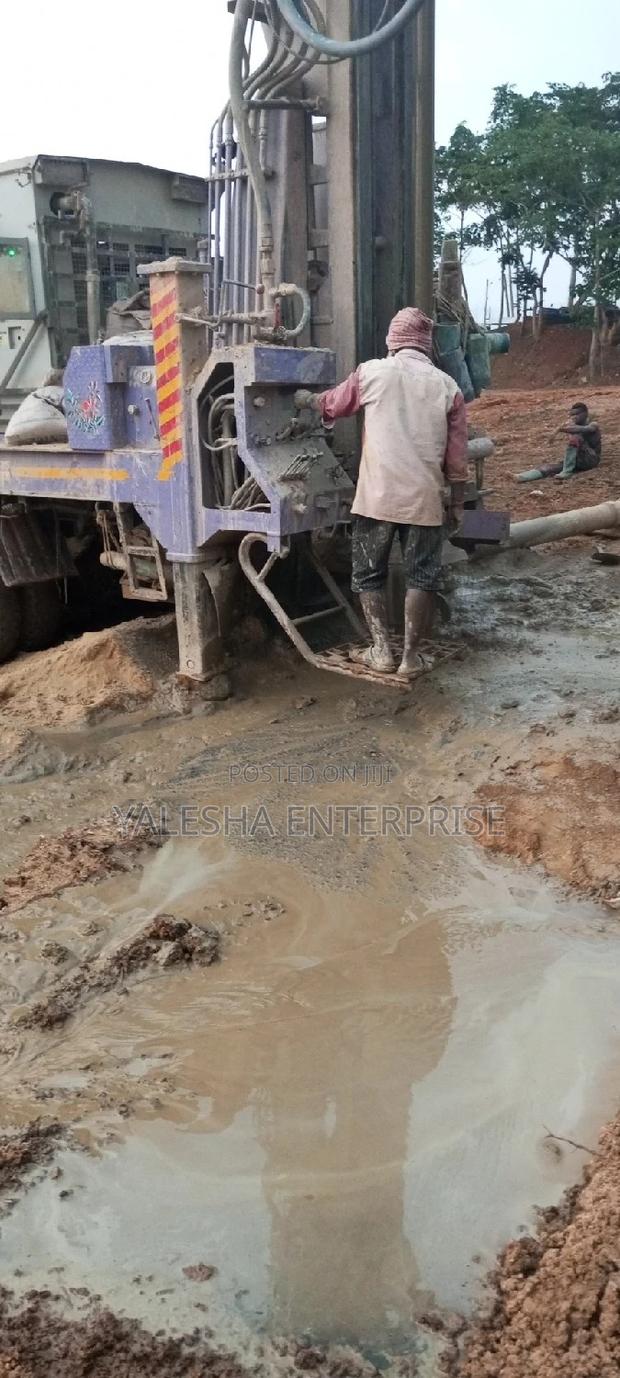 Borehole Drilling Services With Quality Pump and Blue Pipes · Photo 3