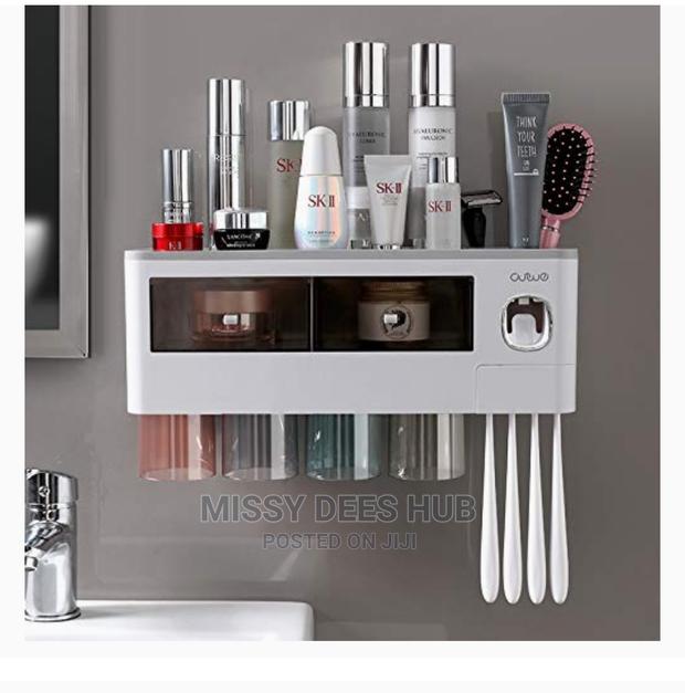 Toothpaste Dispenser and Toothbrush Holder With 4 Cups · Photo 1