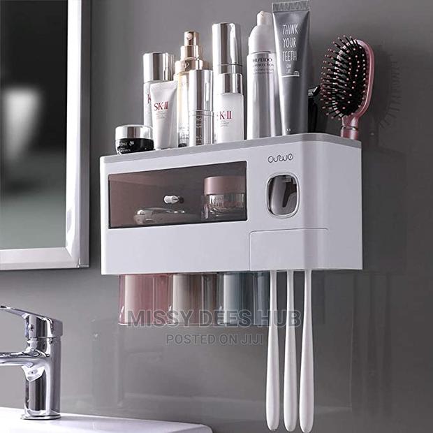 Toothpaste Dispenser and Toothbrush Holder With 4 Cups · Photo 2