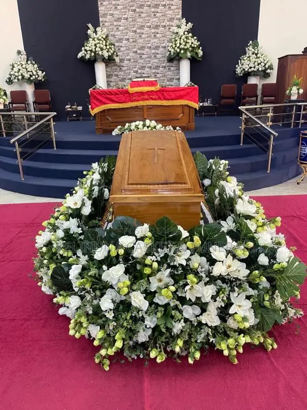 Beautiful Floral Arrangements Around Casket/Coffin · Photo 1