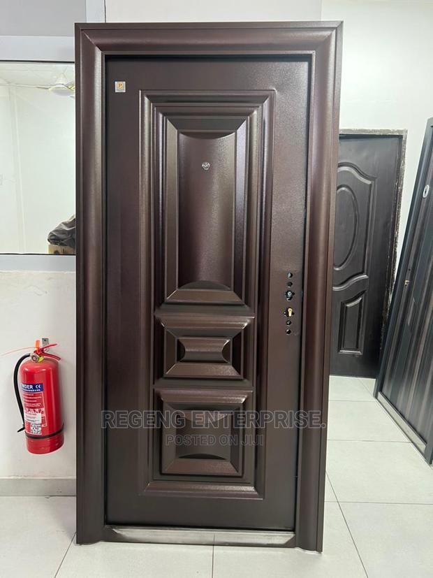 Brown Metal Single Security Door With Accessories · Photo 1