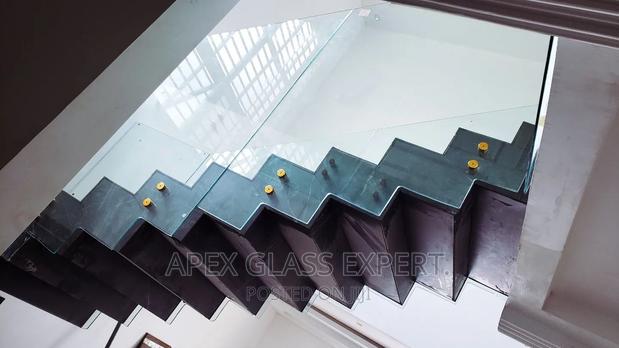 Staircase Glass With Gold Railing Support. · Photo 3