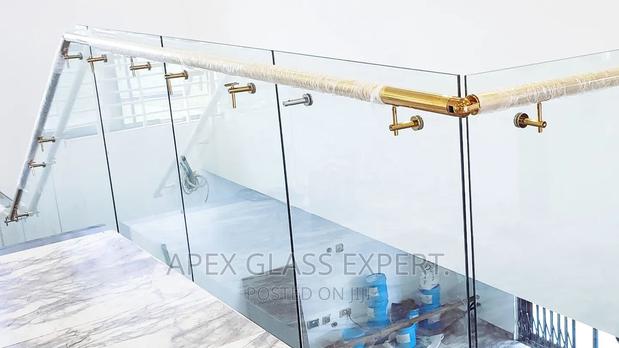 Staircase Glass With Gold Railing Support. · Photo 4