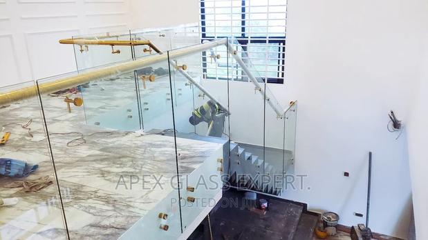 Staircase Glass With Gold Railing Support. · Photo 1