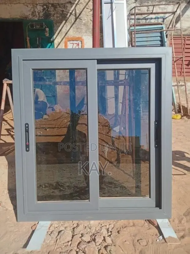 Modern Grey Aluminium Sliding Window With Blue Tinted Glass · Photo 1