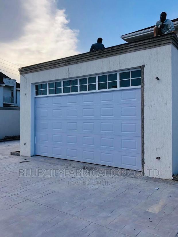 American Automated Garage Door and Fanlight on Top 16ft X8ft · Photo 1