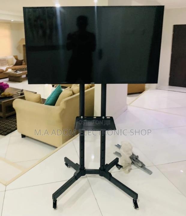 (Black)Purchase Moveable Tv Trolly for 32”-70” Tv. · Photo 1