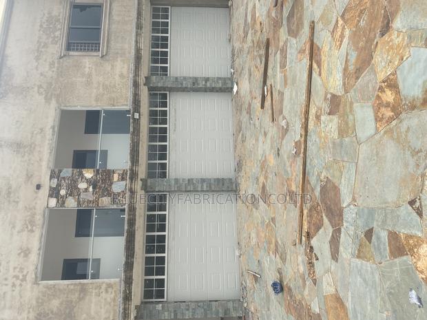 American Triple Automatic Garage Doors · Photo 1