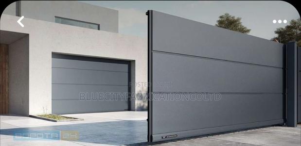 Black Automatic Garage Door With Remotes · Photo 1