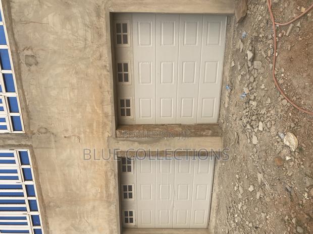 Automated Double Garage Door With Fanlight · Photo 1