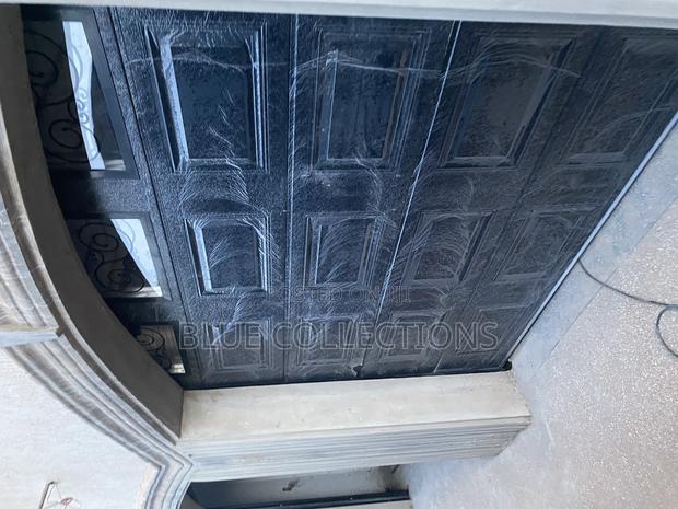Automated Black Garage Door · Photo 1
