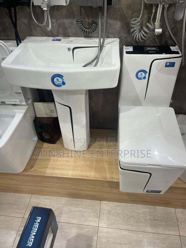 Black and White Water Closet With Wash Hand Basin and Stand · Photo 1