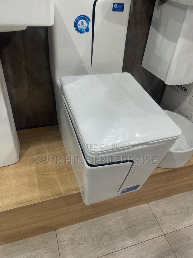 Black and White Water Closet With Wash Hand Basin and Stand · Photo 2