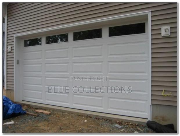 18 ×8 Automated Garage Door With Fanlight and Remote · Photo 1