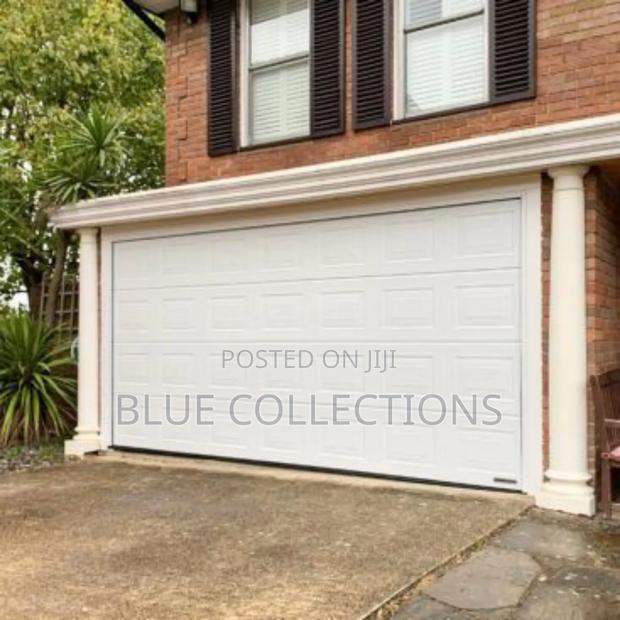 12×8 Foreign Automated System Garage Door · Photo 1