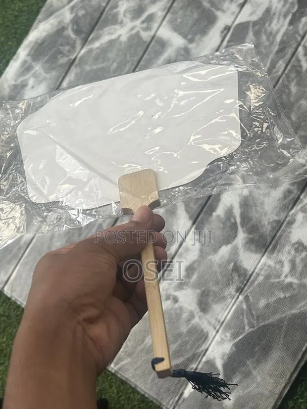 This Is a Fan With Wooden Handle · Photo 1
