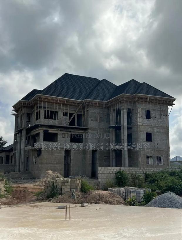 Shingles Roofing and Concrete Parapet · Photo 1