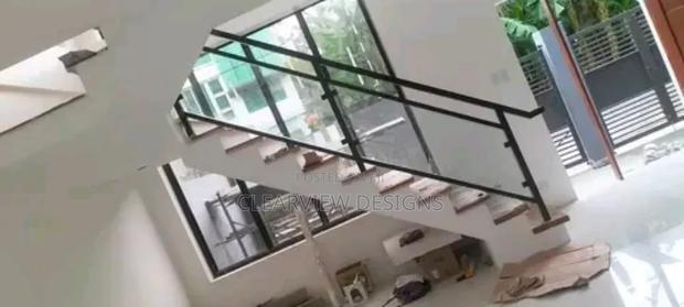 Safe Glass and Metal Stair Railing · Photo 1
