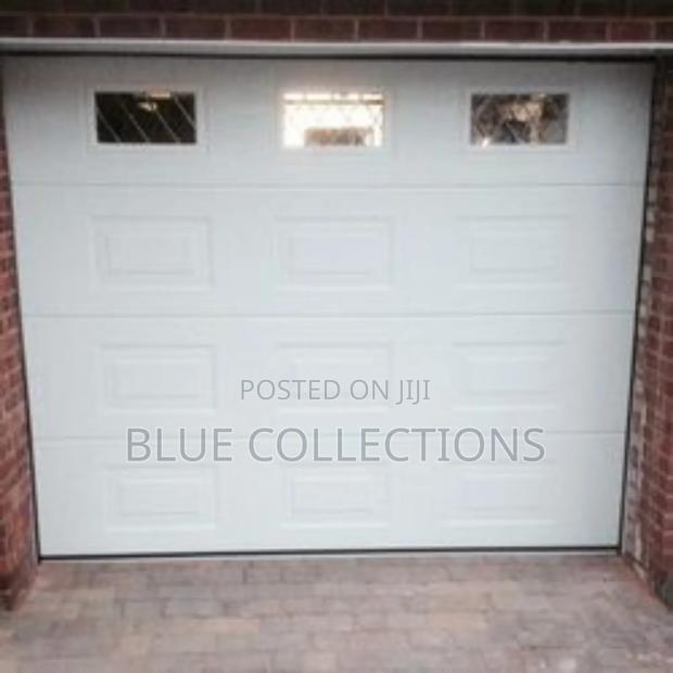 Stylish Automated Garage Door With Fanlight · Photo 1