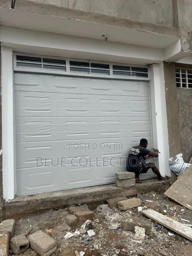 Automated Garage Door With Fanlight · Photo 1