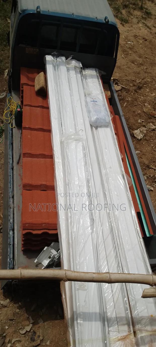 Installation of Rain Gutter and Stone Coated Roofing Sheet.