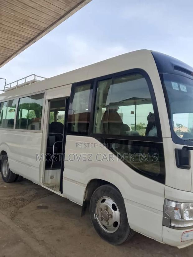 Car Rentals Rent a Toyota Coaster Buses for Your Travels · Photo 1
