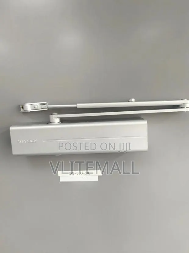 Assa Abloy Surface-Mounted Door Closer, Featuring a Silver Finish · Photo 1