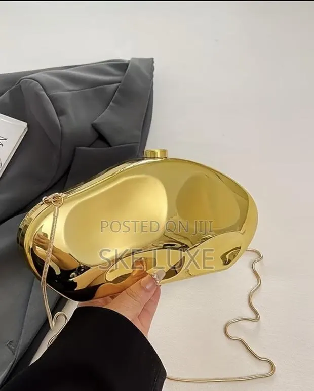 Luxury Metallic Sculpted Clutch Bag · Photo 1