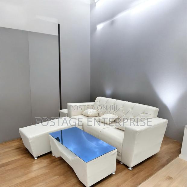 Neatly Designed Duarble Sofa With a Centre Glass Table · Photo 1