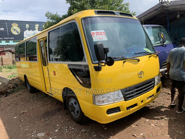 Toyota Coaster 2014 Yellow · Photo 1