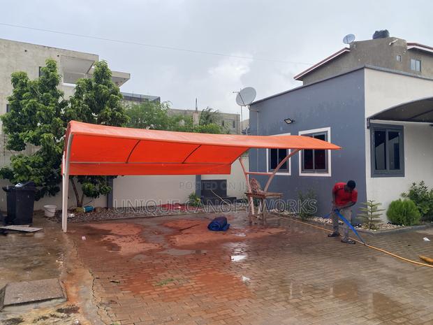 Orange Carport to Match Roofing · Photo 2