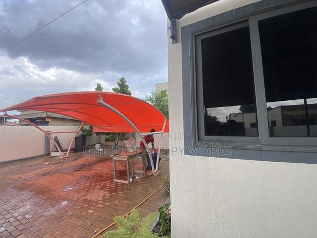 Orange Carport to Match Roofing · Photo 1