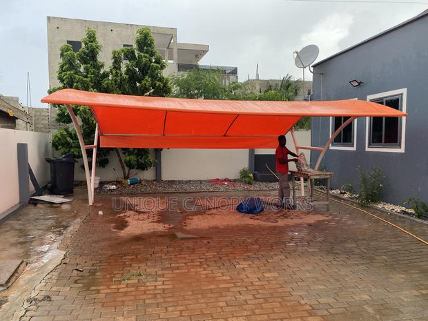 Orange Carport to Match Roofing · Photo 3