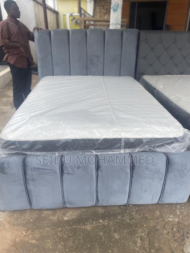 A Double Standard Bed Frame With Mattress · Photo 1