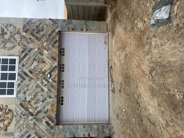 Canadian Automated Garage Door With Fanlight and Remote · Photo 1