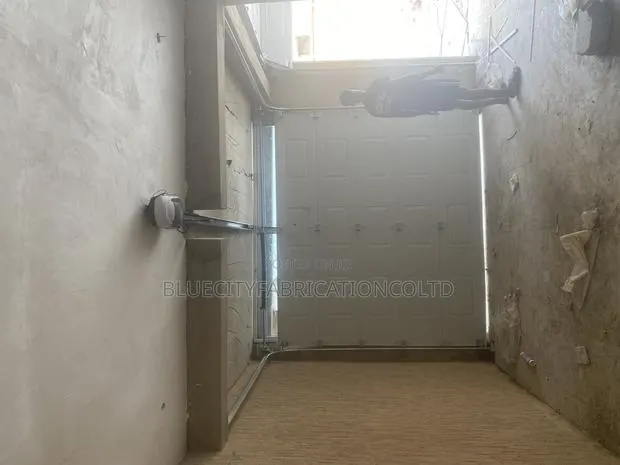 Automated Garage Door With Fanlight and Remote · Photo 1