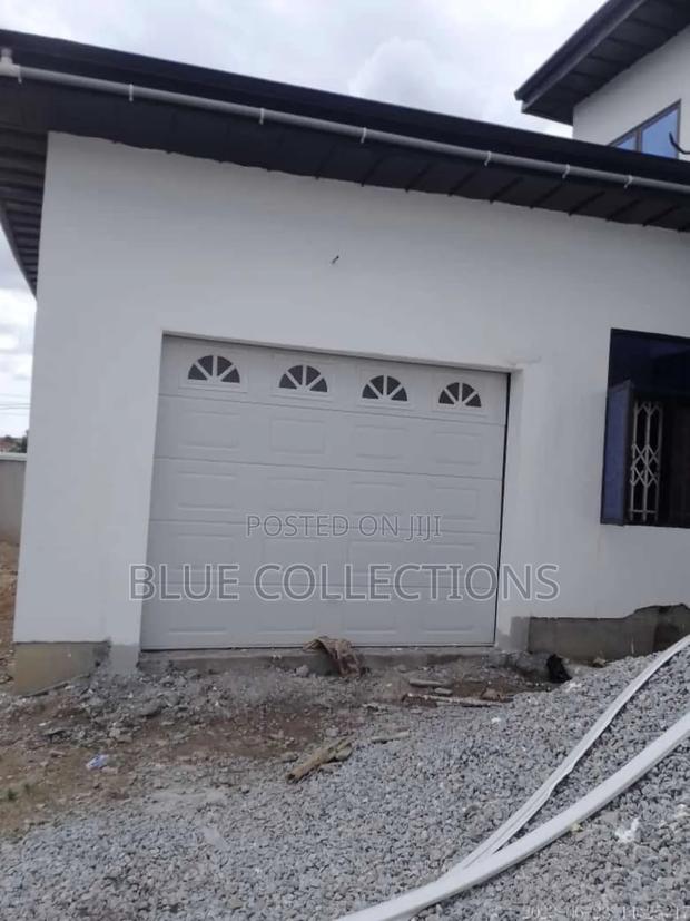 Smart Garage Door With Fanlight and Remote · Photo 1